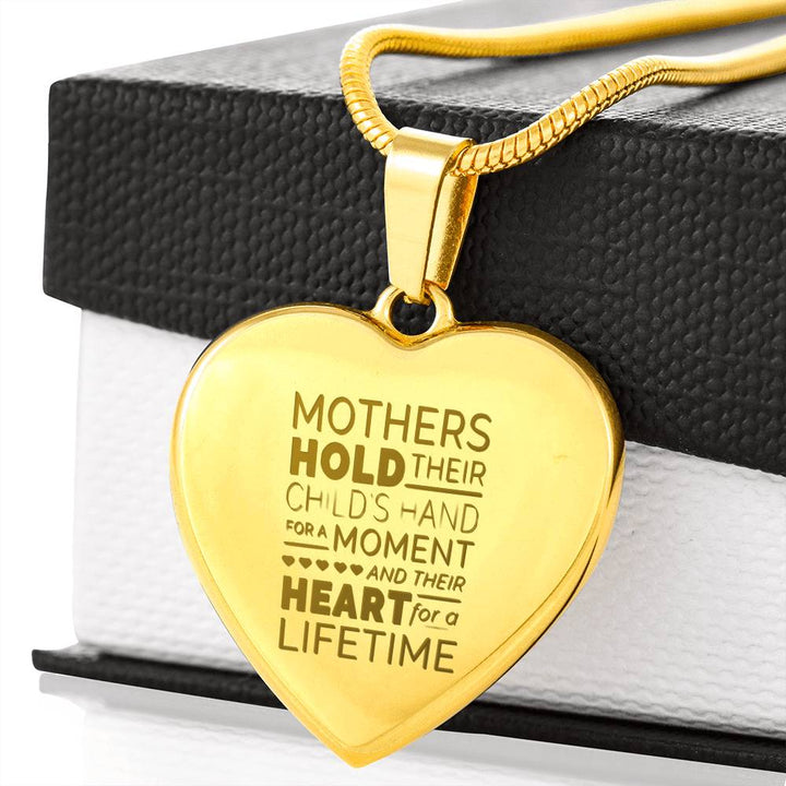 Mother holds their childs hand - Gold