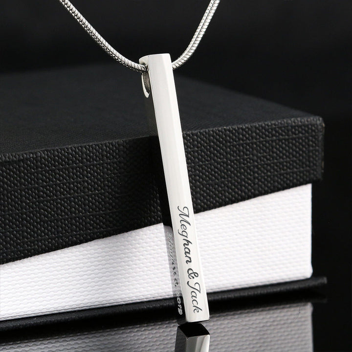 Vertical polished steel stick pendant.